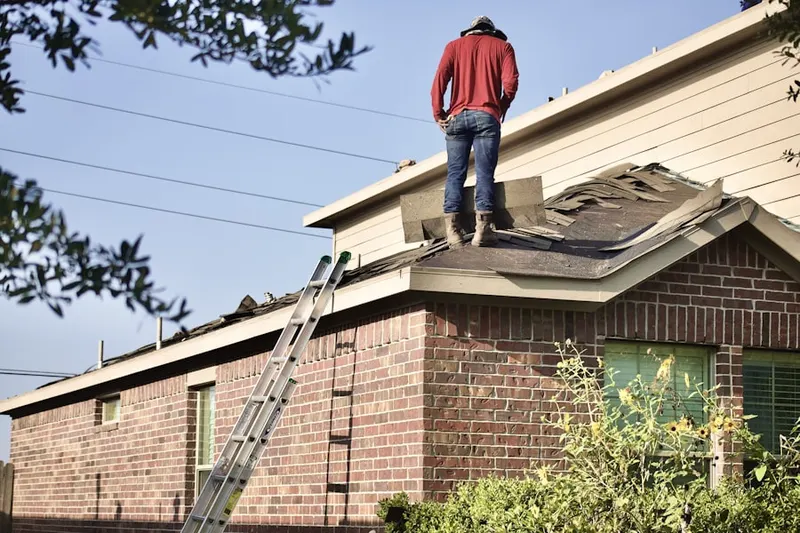 Professional roofer working on a residential roof in Hays Grove